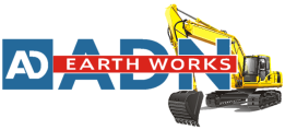 A yellow and black excavator with earth works logo